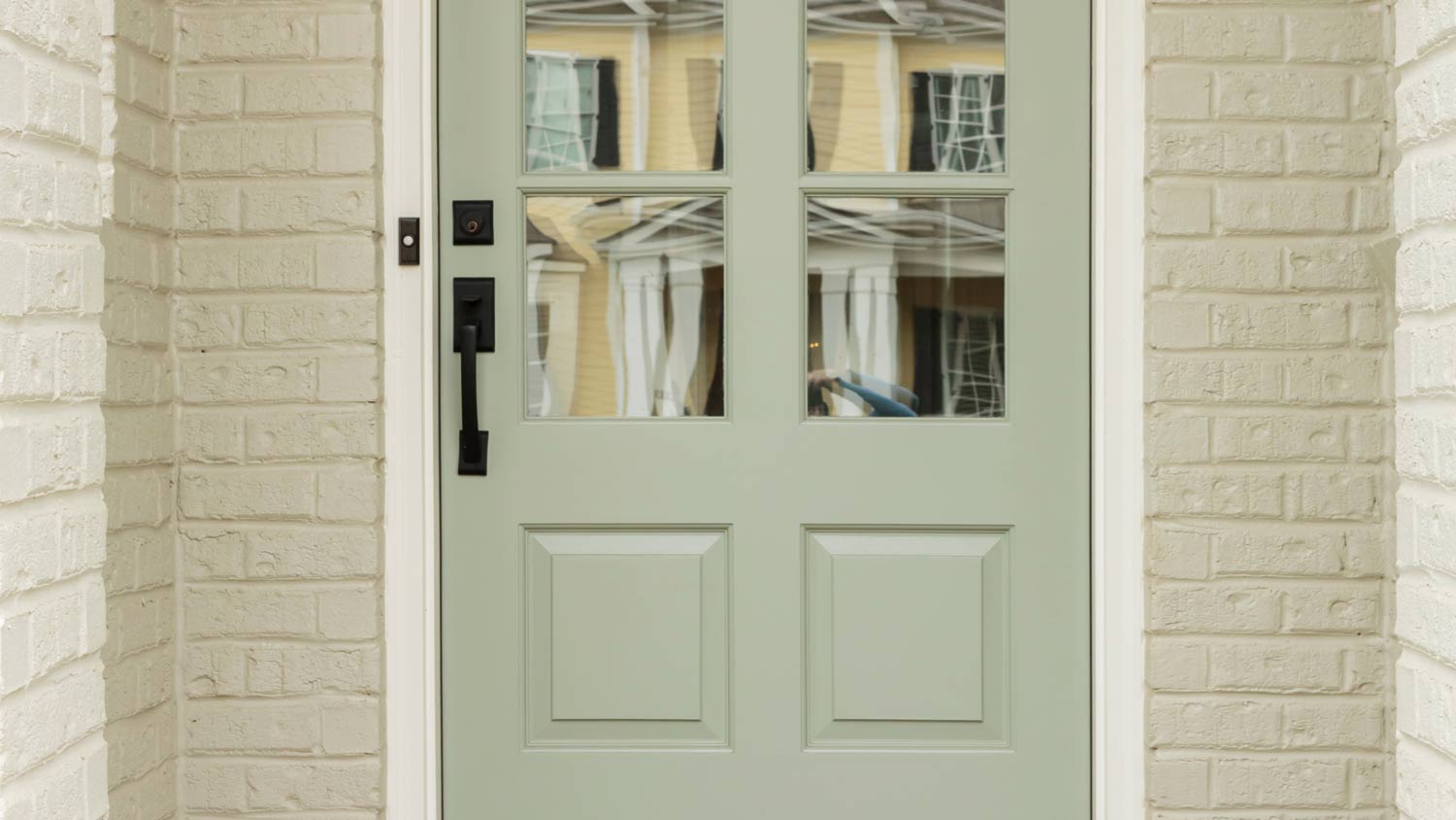 green door with black pull handle