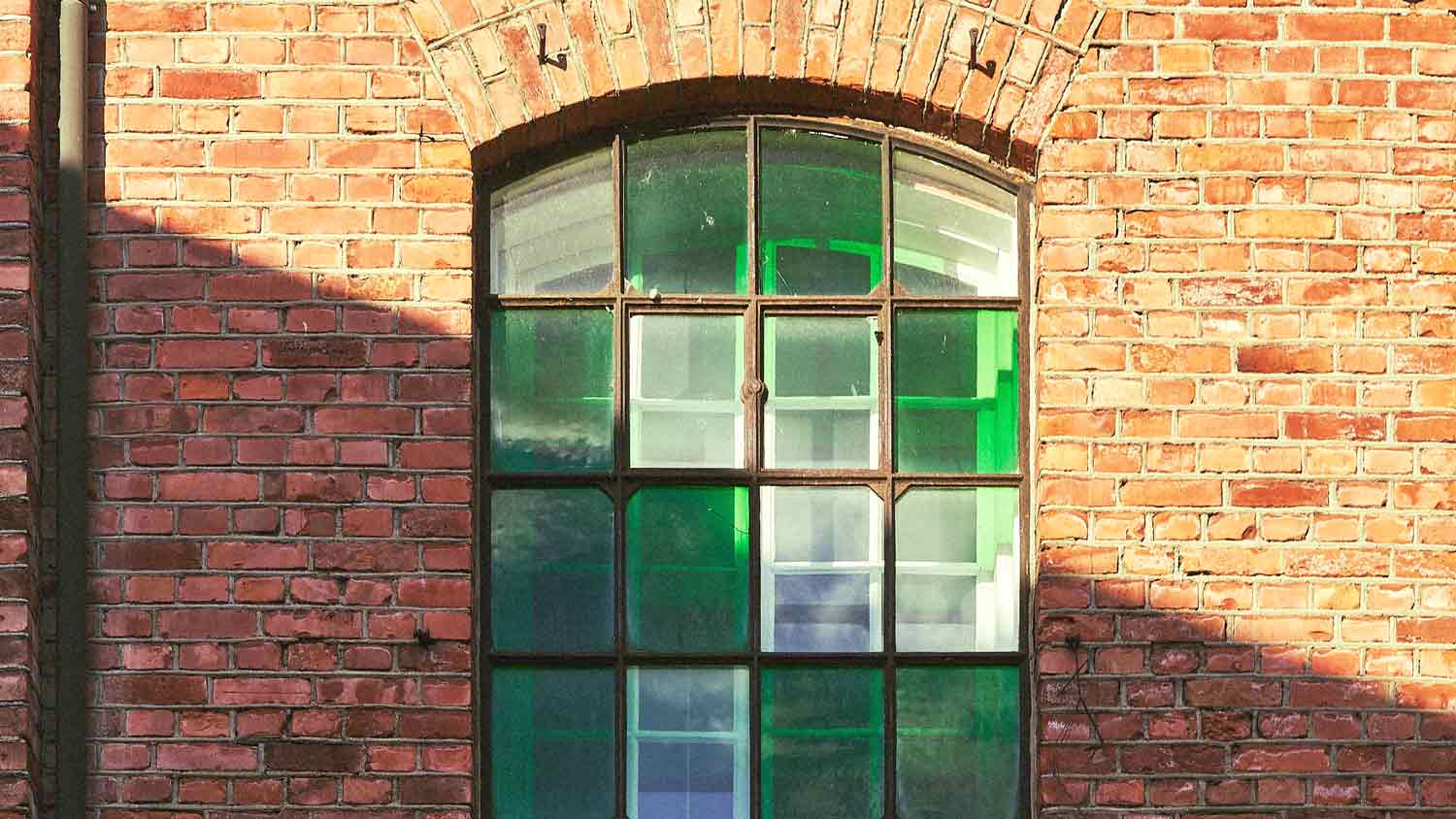 brick house with green tinted windows