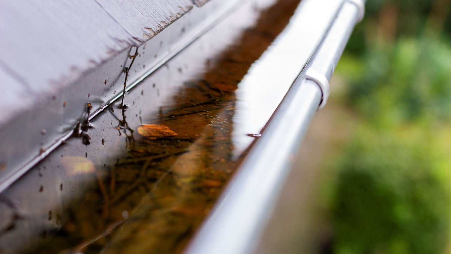 metal gutter full of rainwater