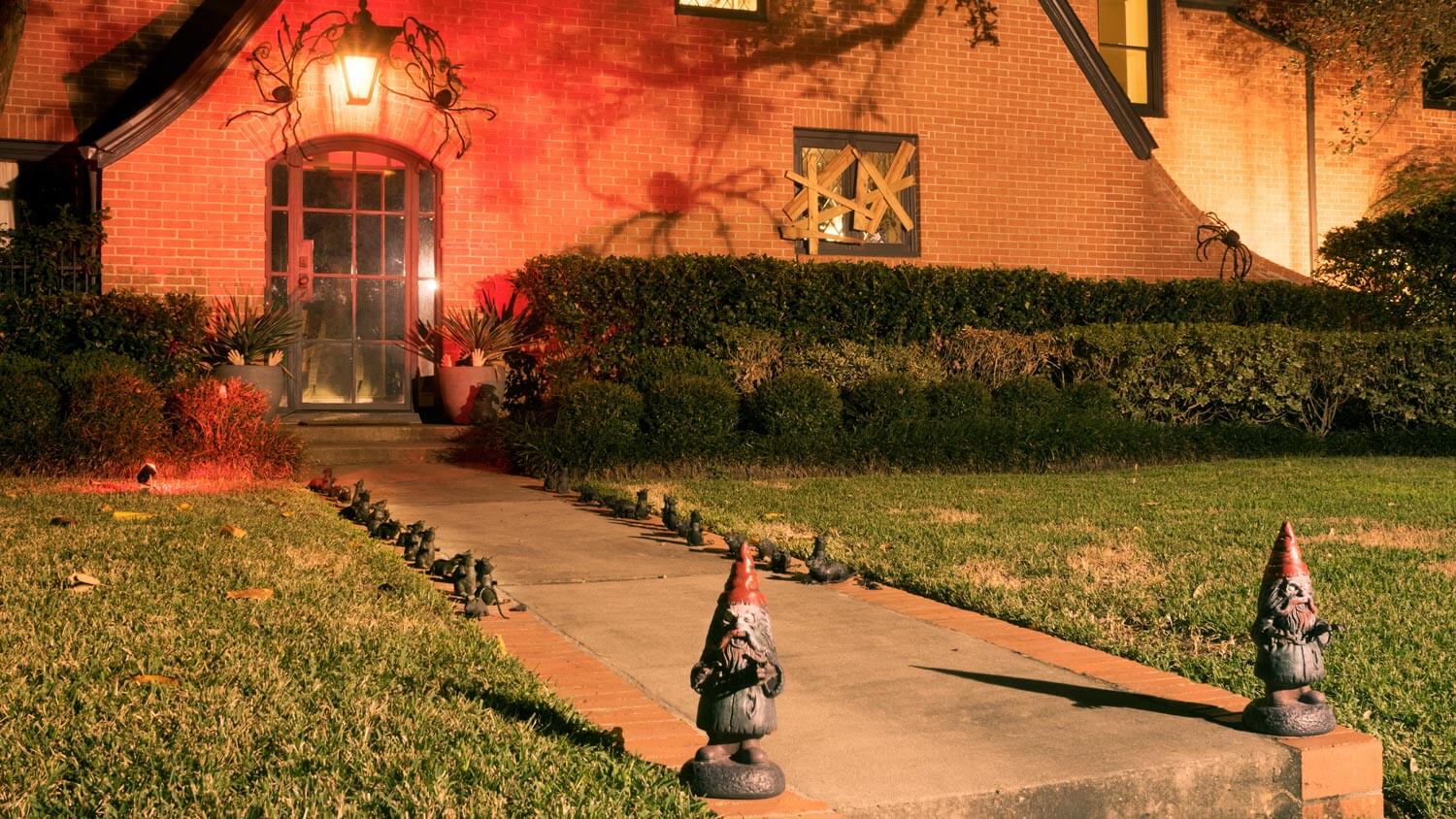 A Halloween decorated house with gnomes and spiders