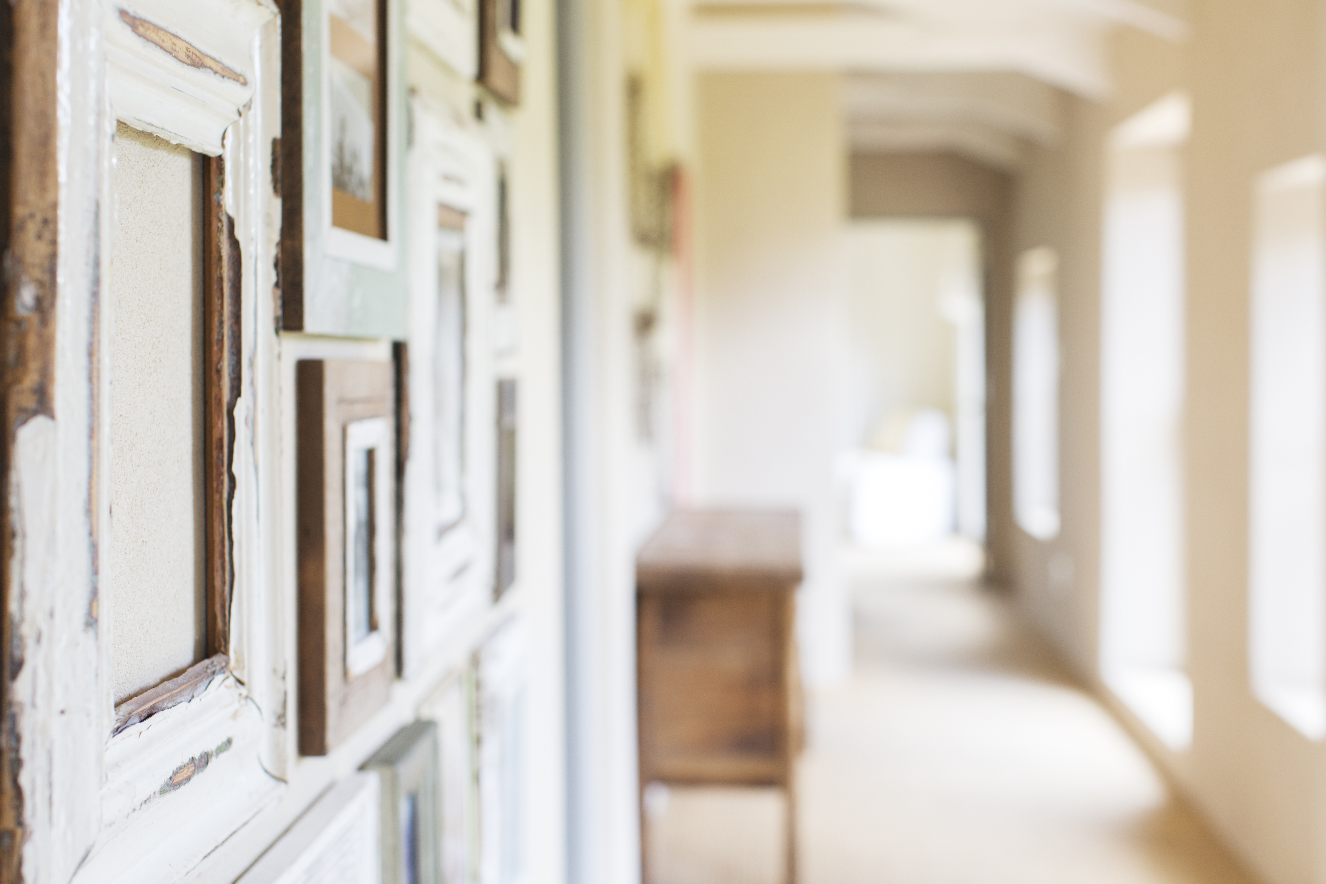 Hallway with photos hanging on wall.