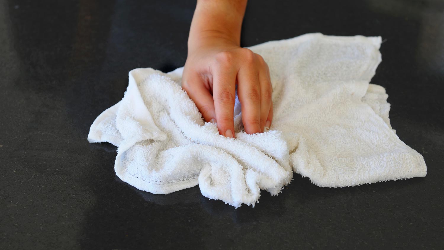 womans hand cleaning table