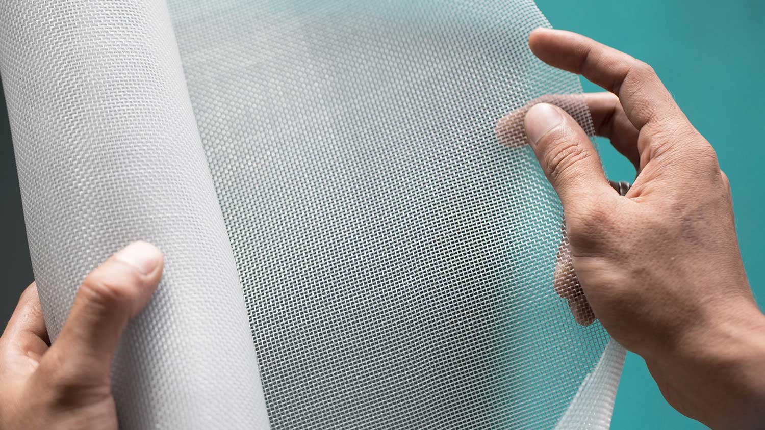 Hando holding window screen roll