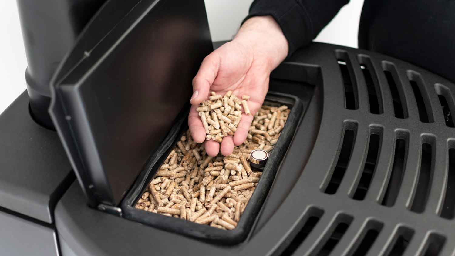 Adding wood pellets to a pellet stove