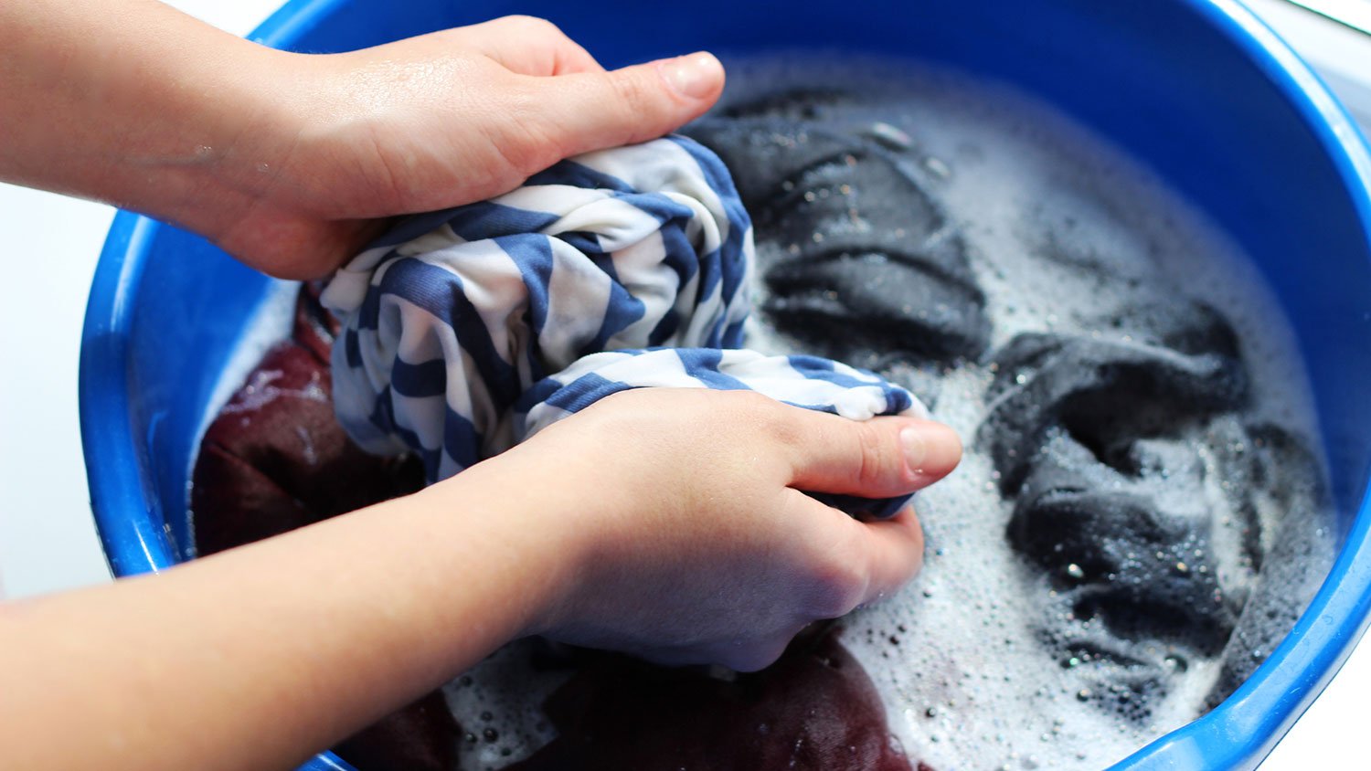 Closeup of a hand scrubbing a garment