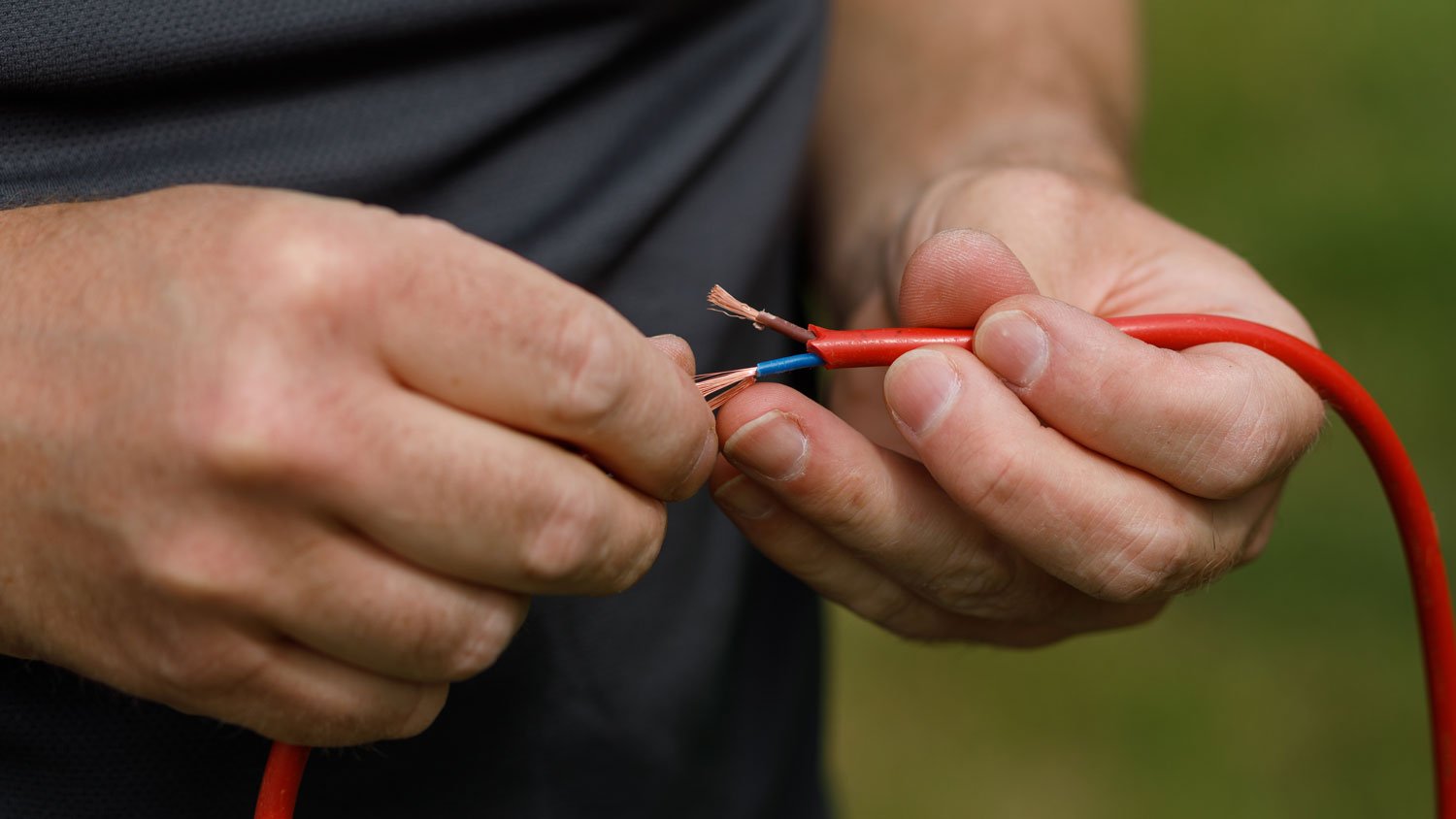 Hands splicing wires together