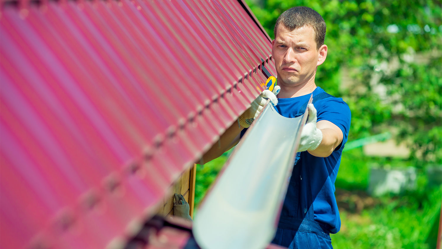 Handyman checking angle of a gutter