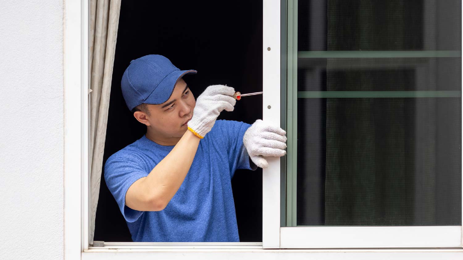 A handyman installing a new window