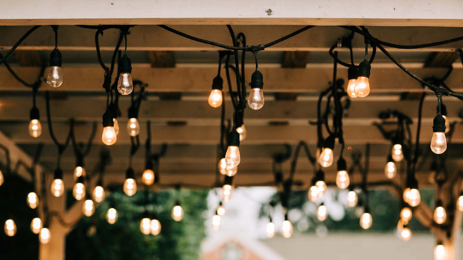 Hanging vintage bulbs on a wooden pergola