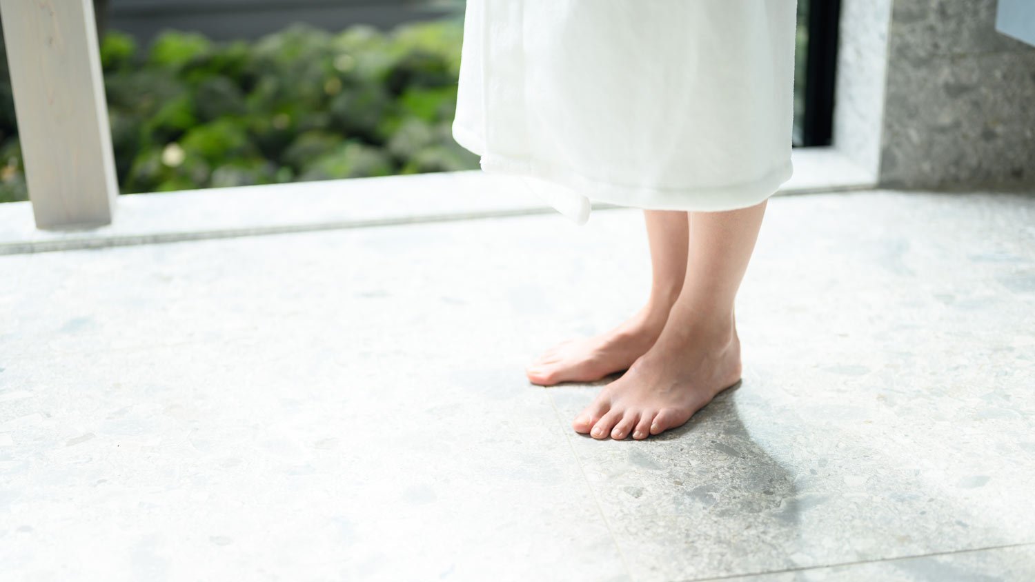 barefoot woman on heated bathroom floor