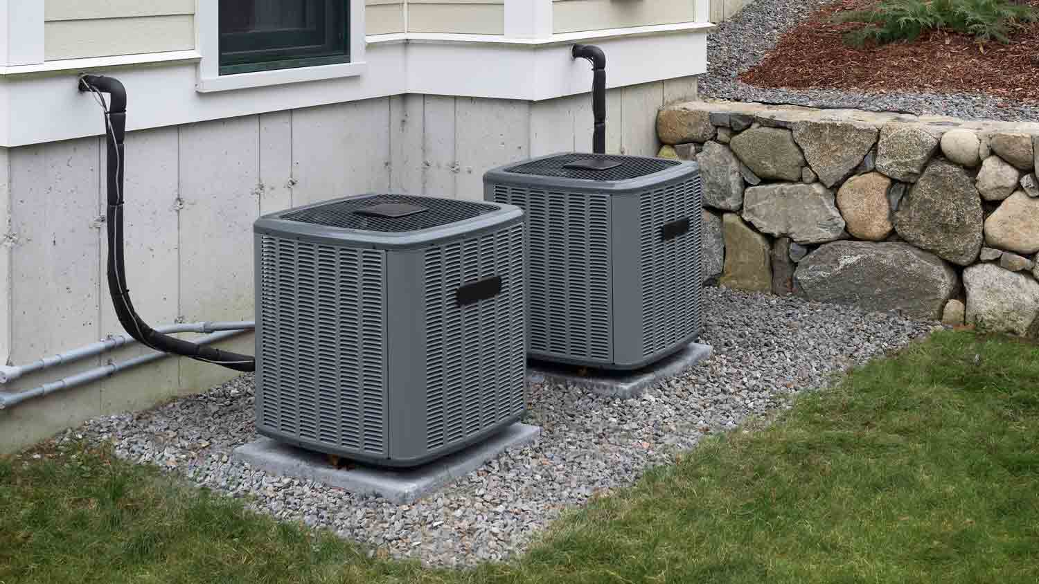 two heating and ac units outside home