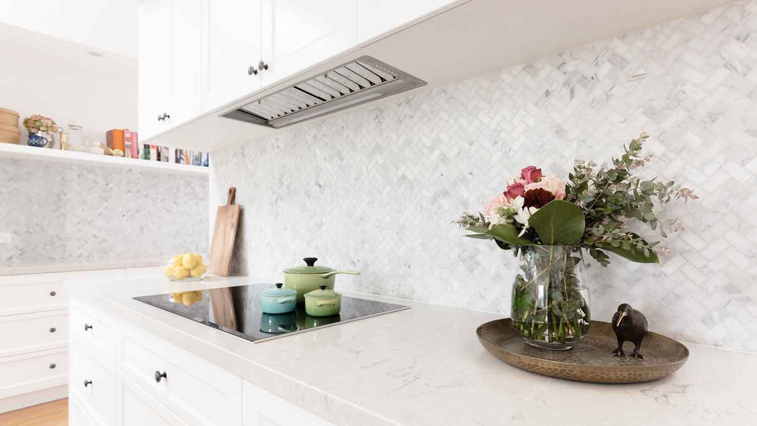 Kitchen backsplash with herringbone mosaic tile pattern