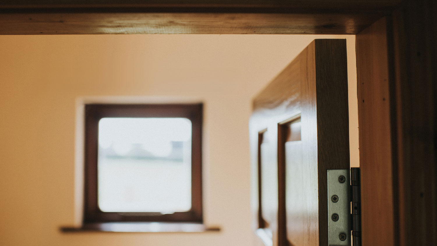 Close-up of a hinge on a wooden door