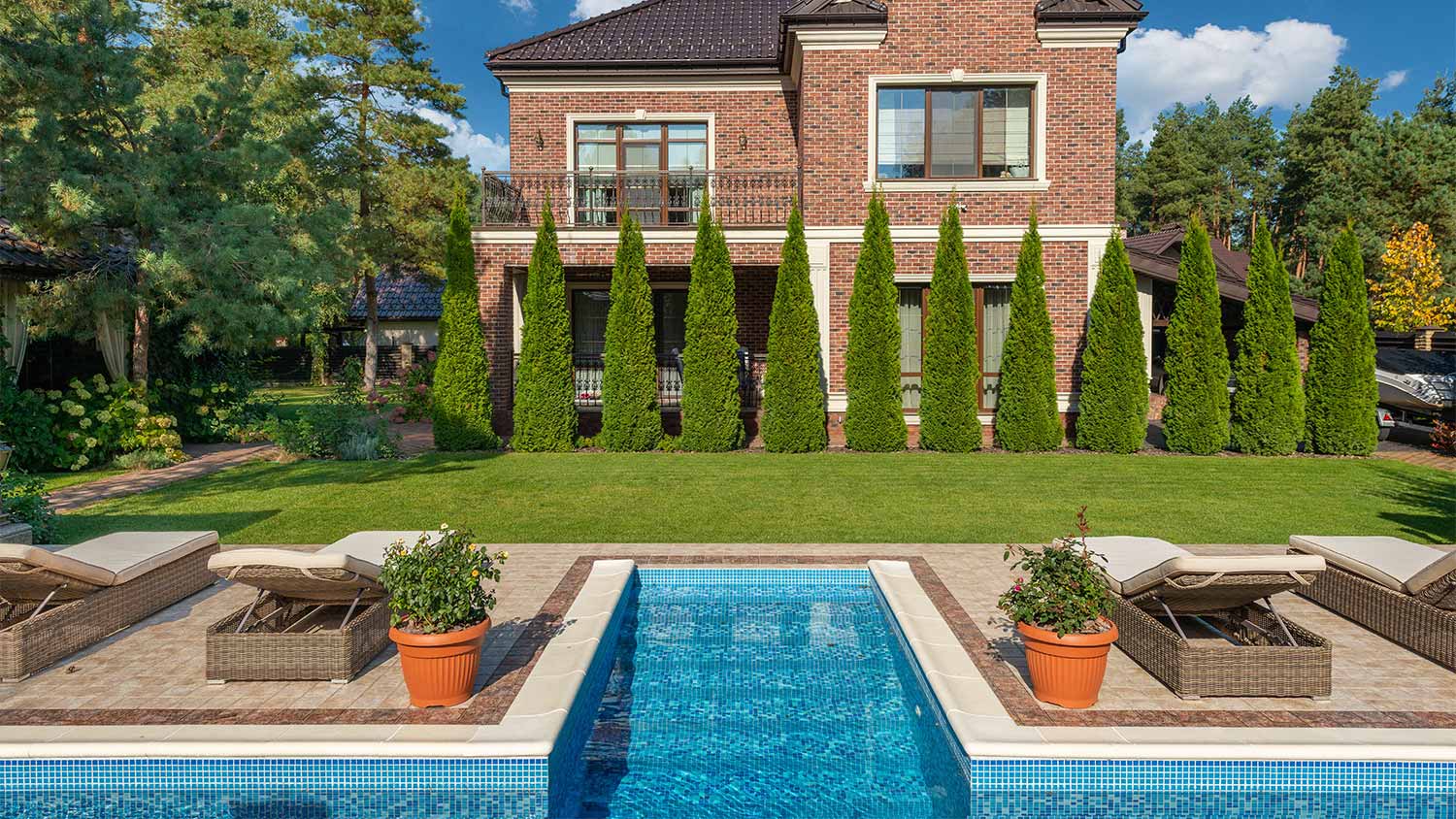 A glistening pool in the backyard of a historic home