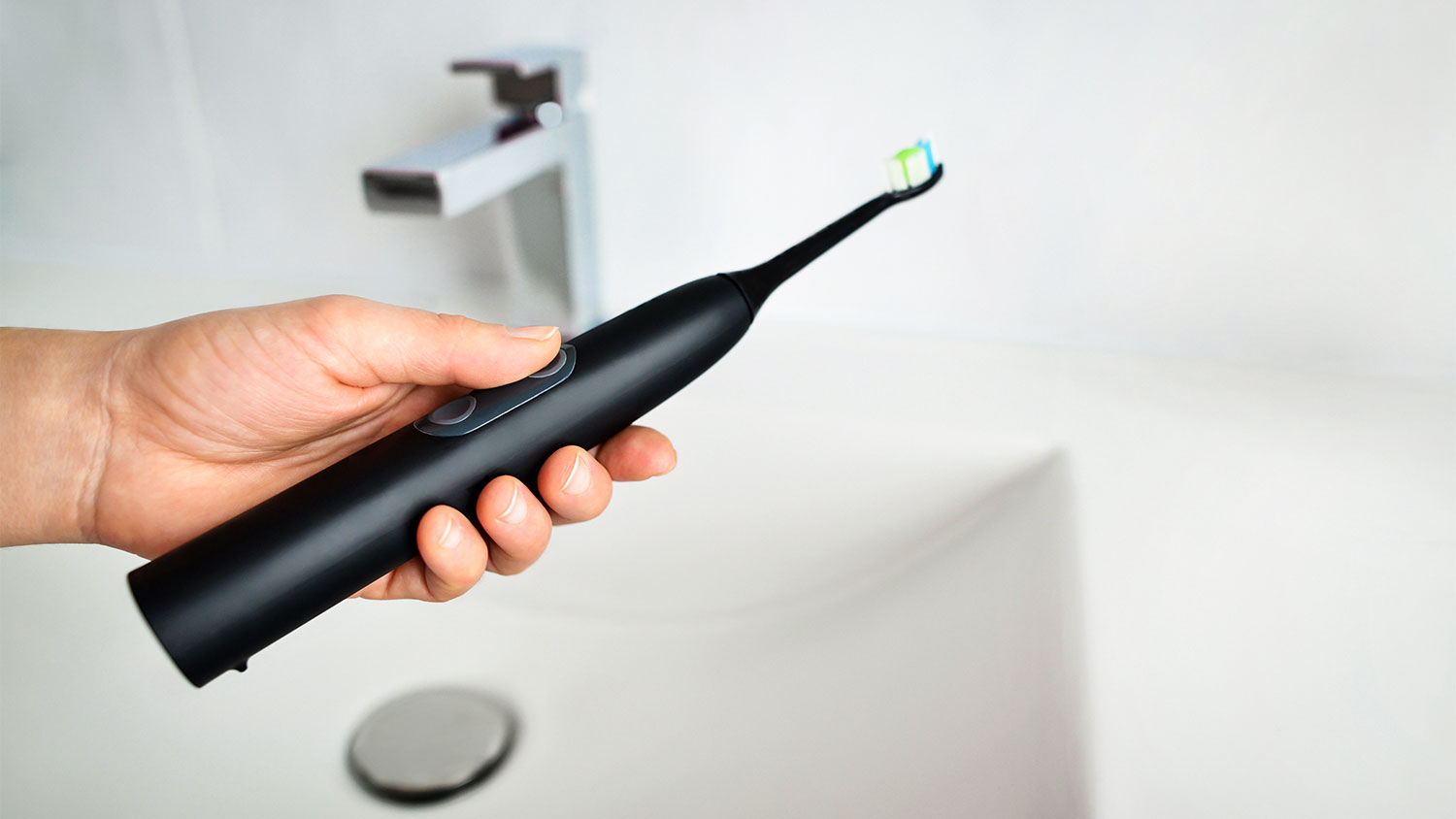 https://media.angi.com/s3fs-public/holding-electric-toothbrush.jpeg?impolicy=leadImage