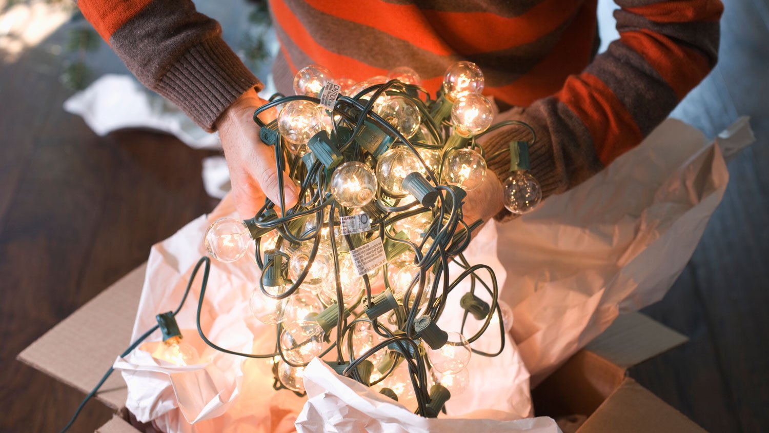 Man Holding Tangled String of Christmas Lights