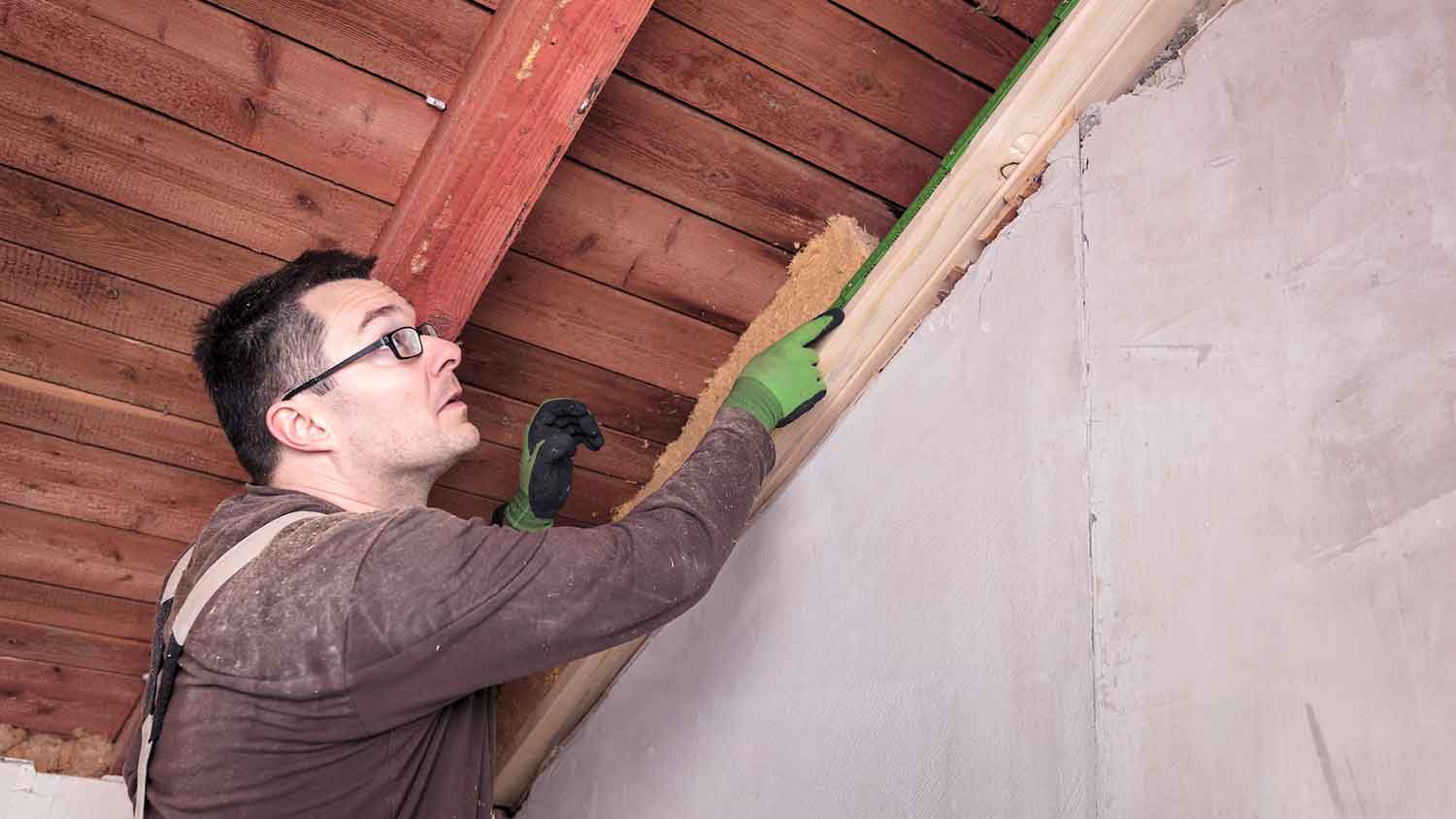 Home inspector in the attic looking for signs of moisture