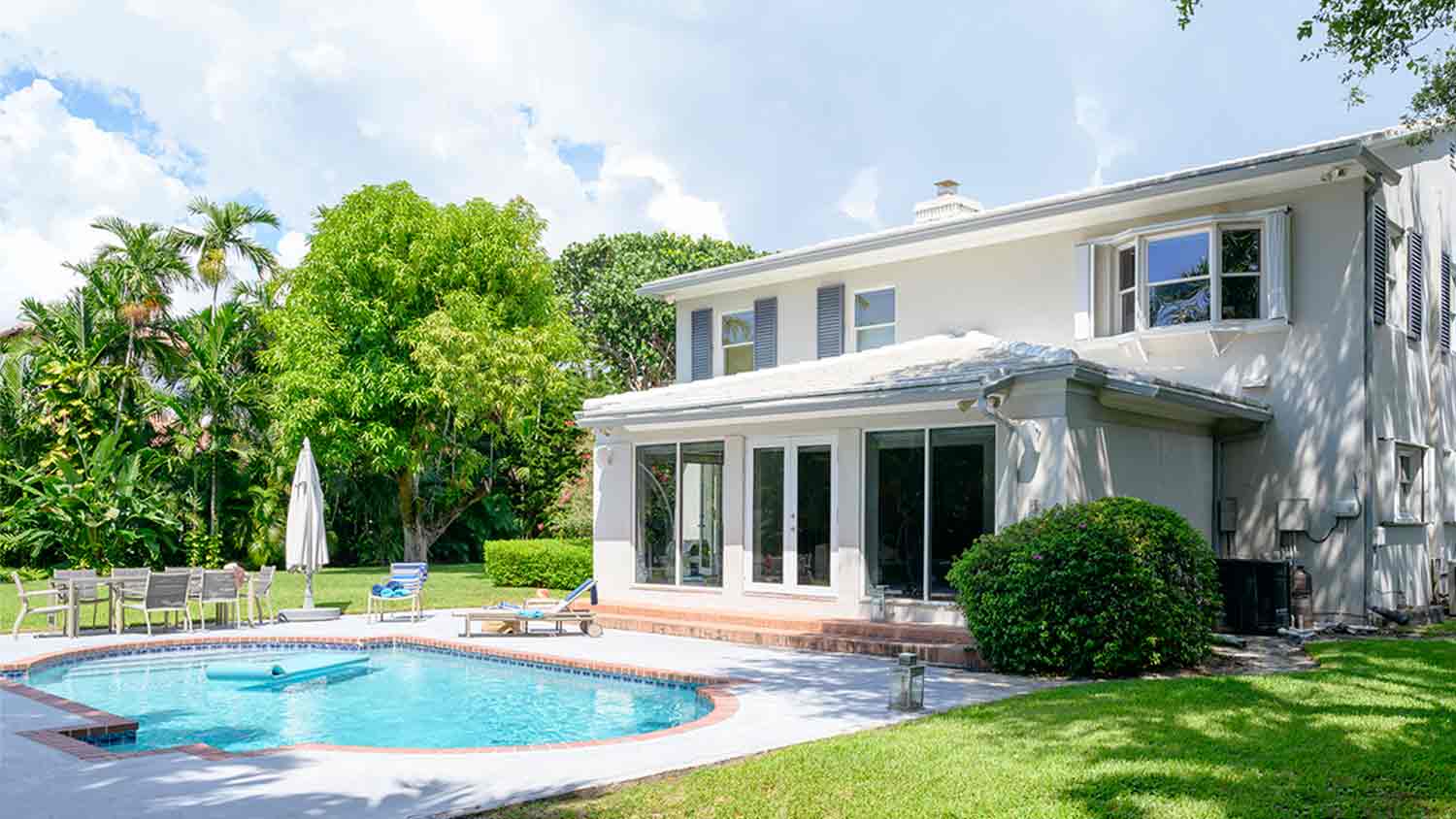 two story home with pool in yard