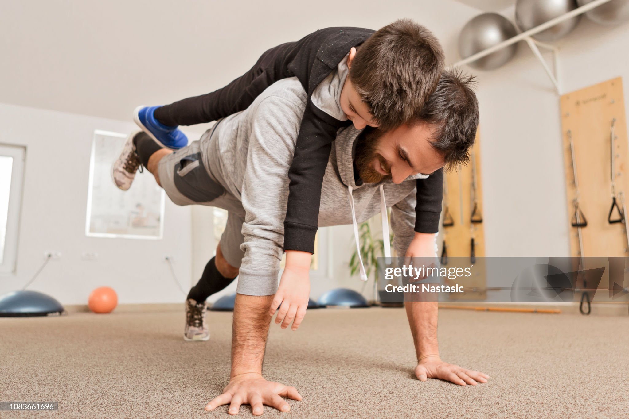 father and son working out in the basement