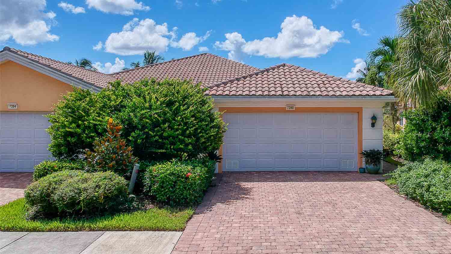 tropical house with a brick driveway