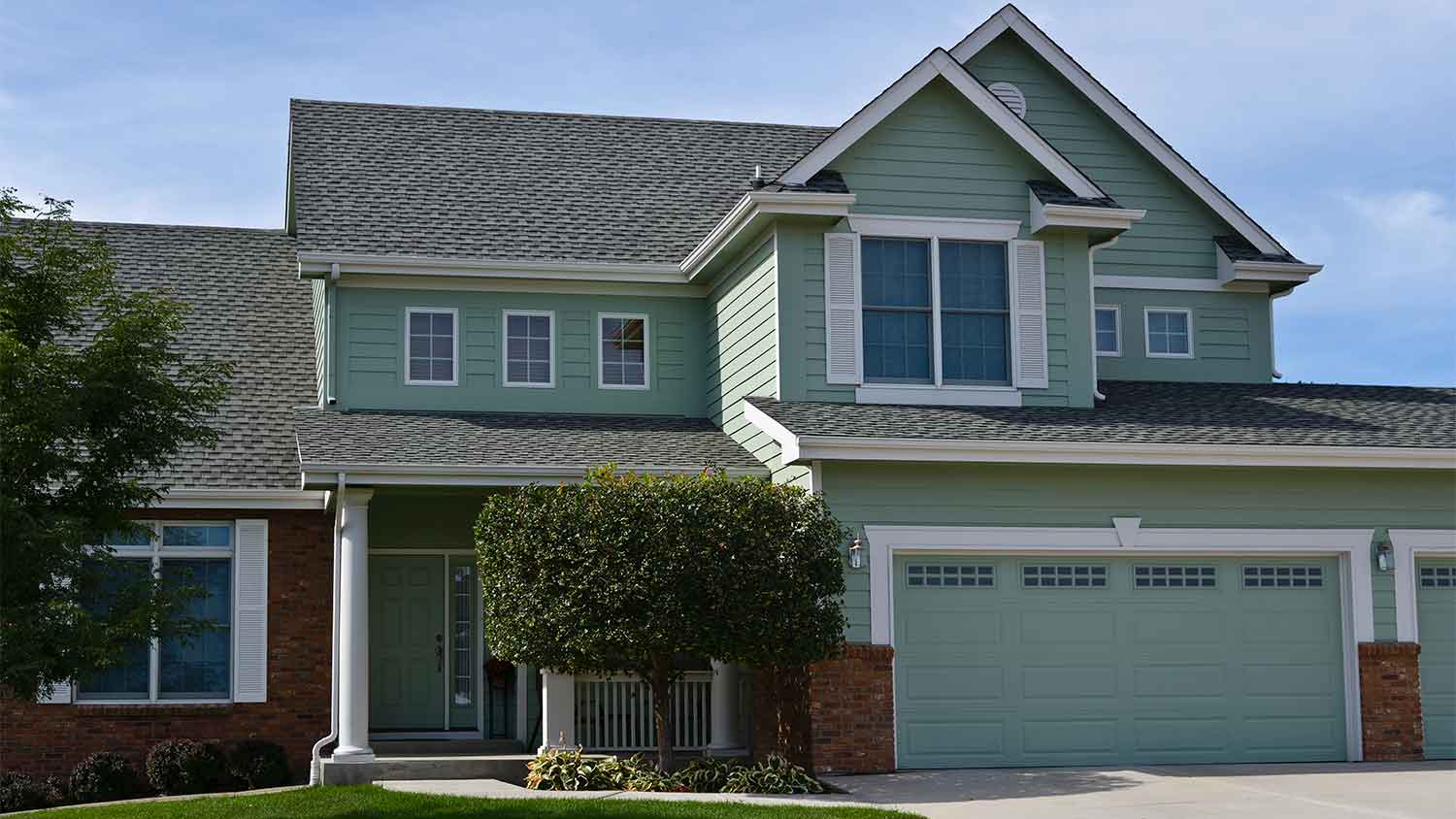 house with sage green siding