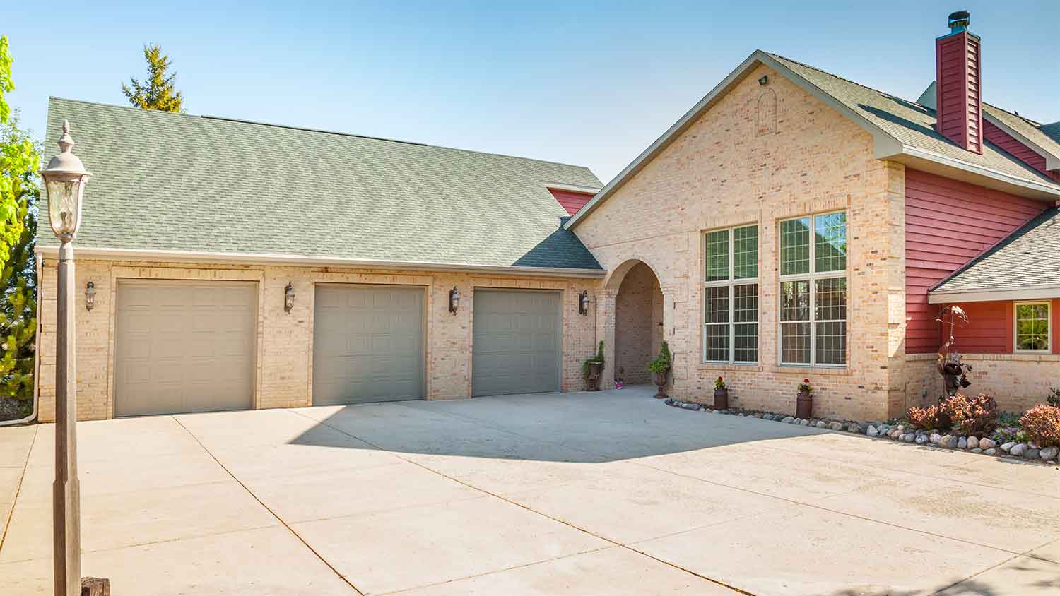 brick home with concrete driveway