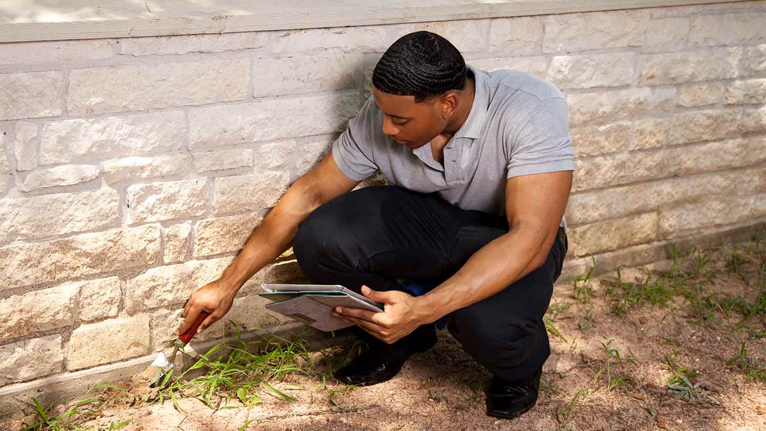 inspector examining home exterior