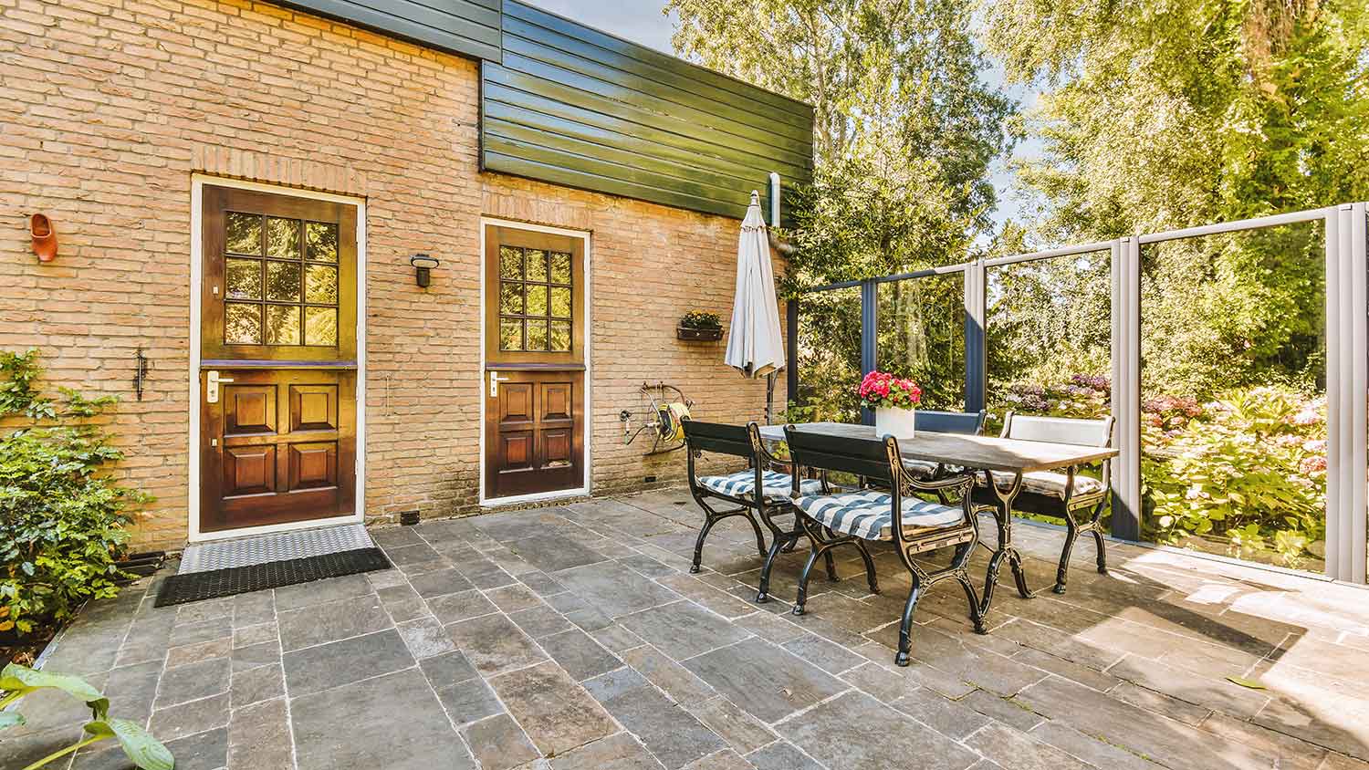 House with paved patio and sitting area