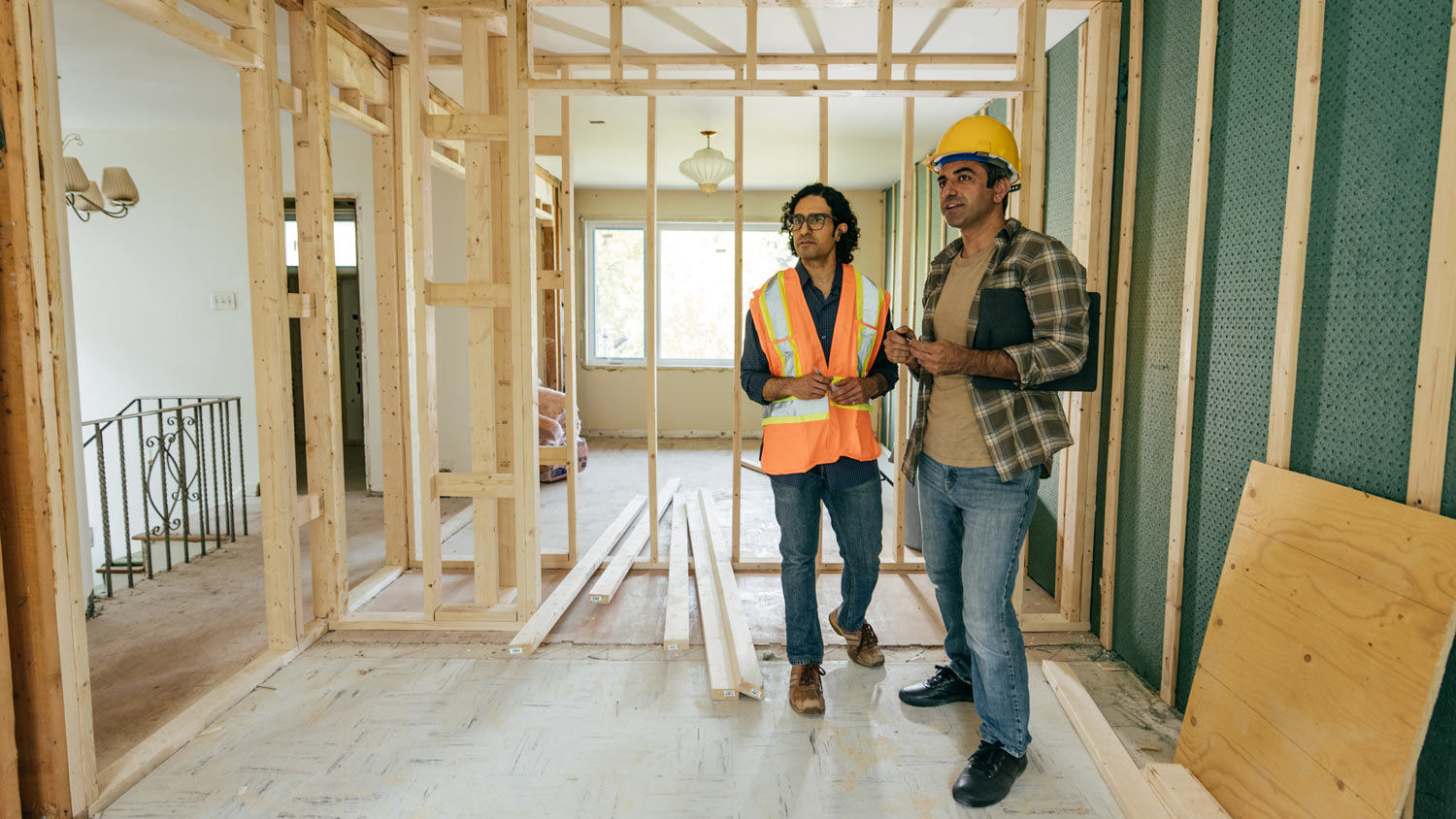 Construction worker is showing to project manager completed design on construction site.