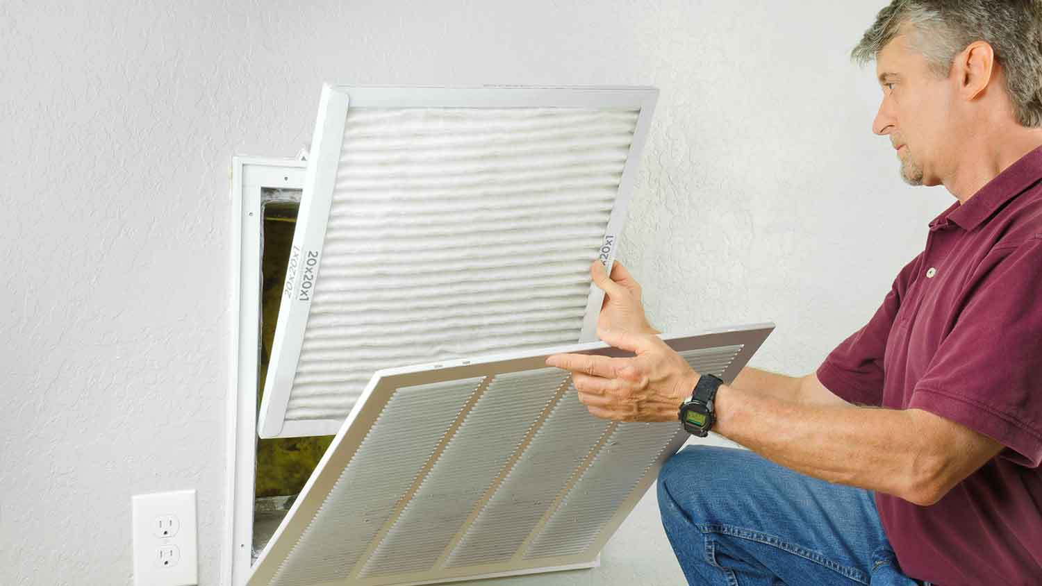 Homeowner changing HVAC air filter