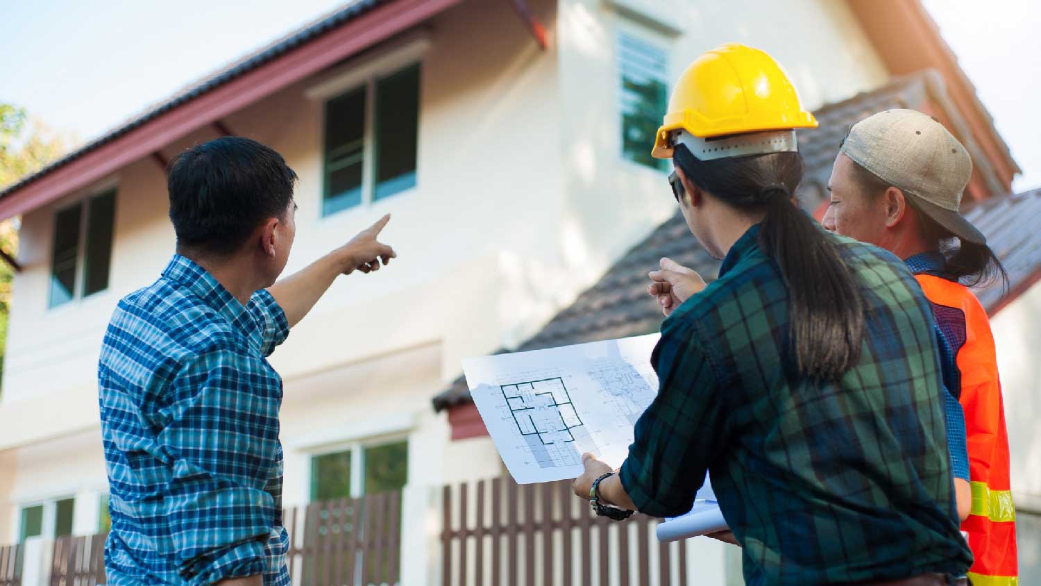 A homeowner discussing with a roof inspector