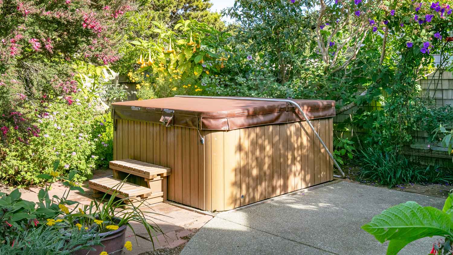 Covered hot tub sitting on the patio