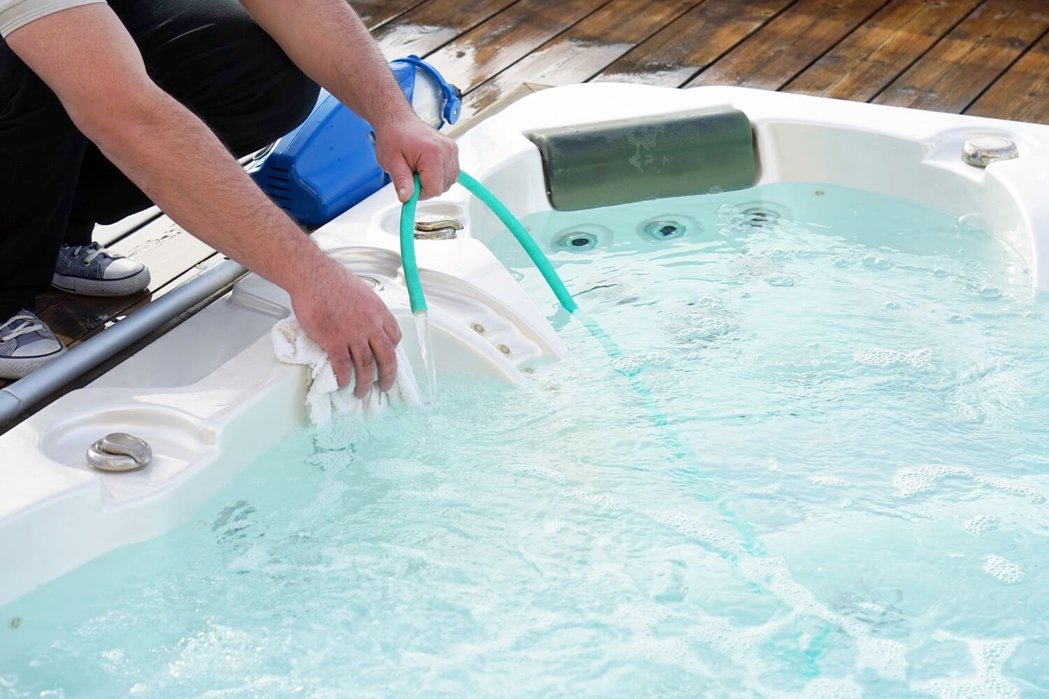 Hot tub maintenance man cleaning hot tub