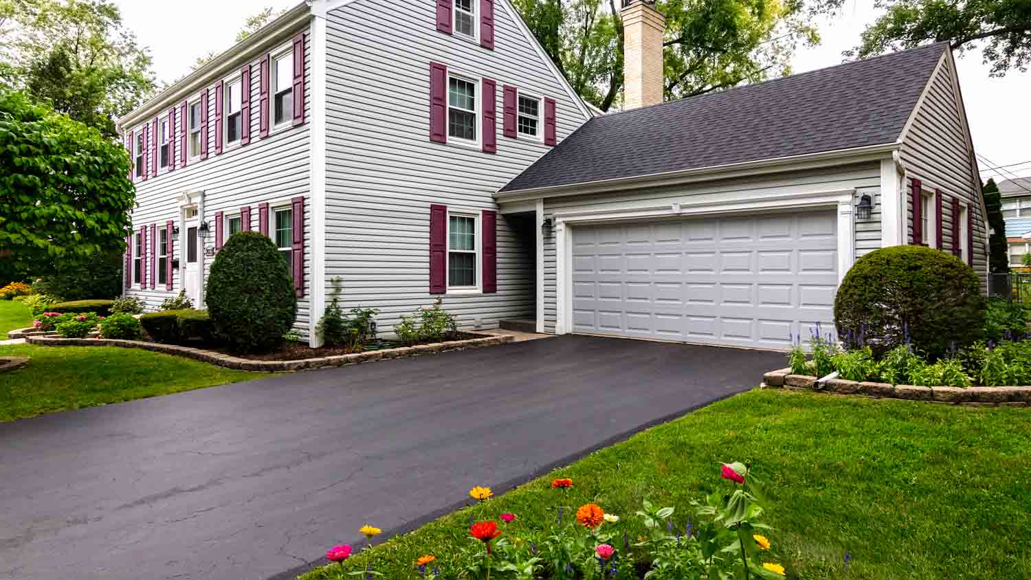 large white house with asphalt driveway