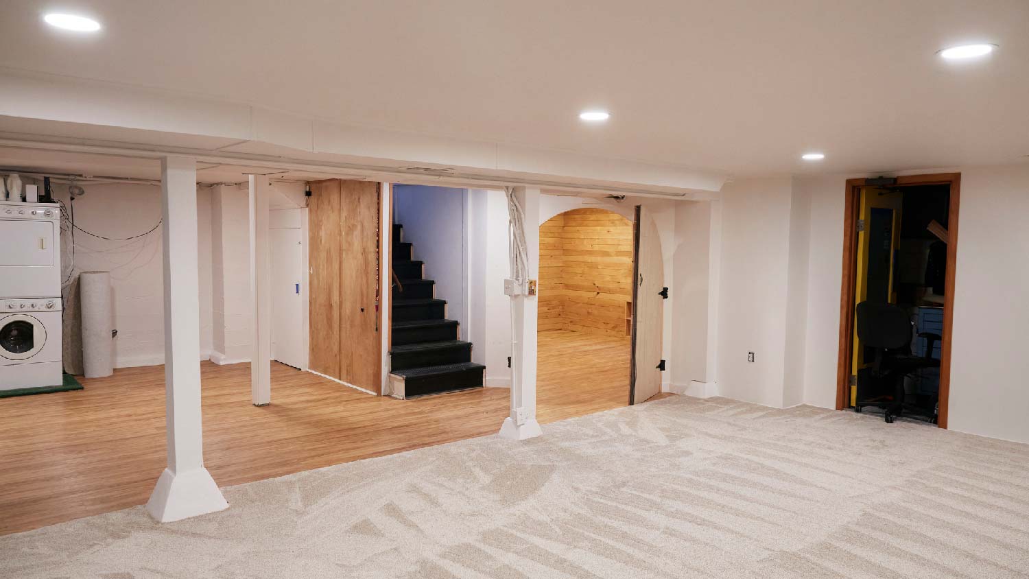 A house’s basement with carpet and vinyl flooring