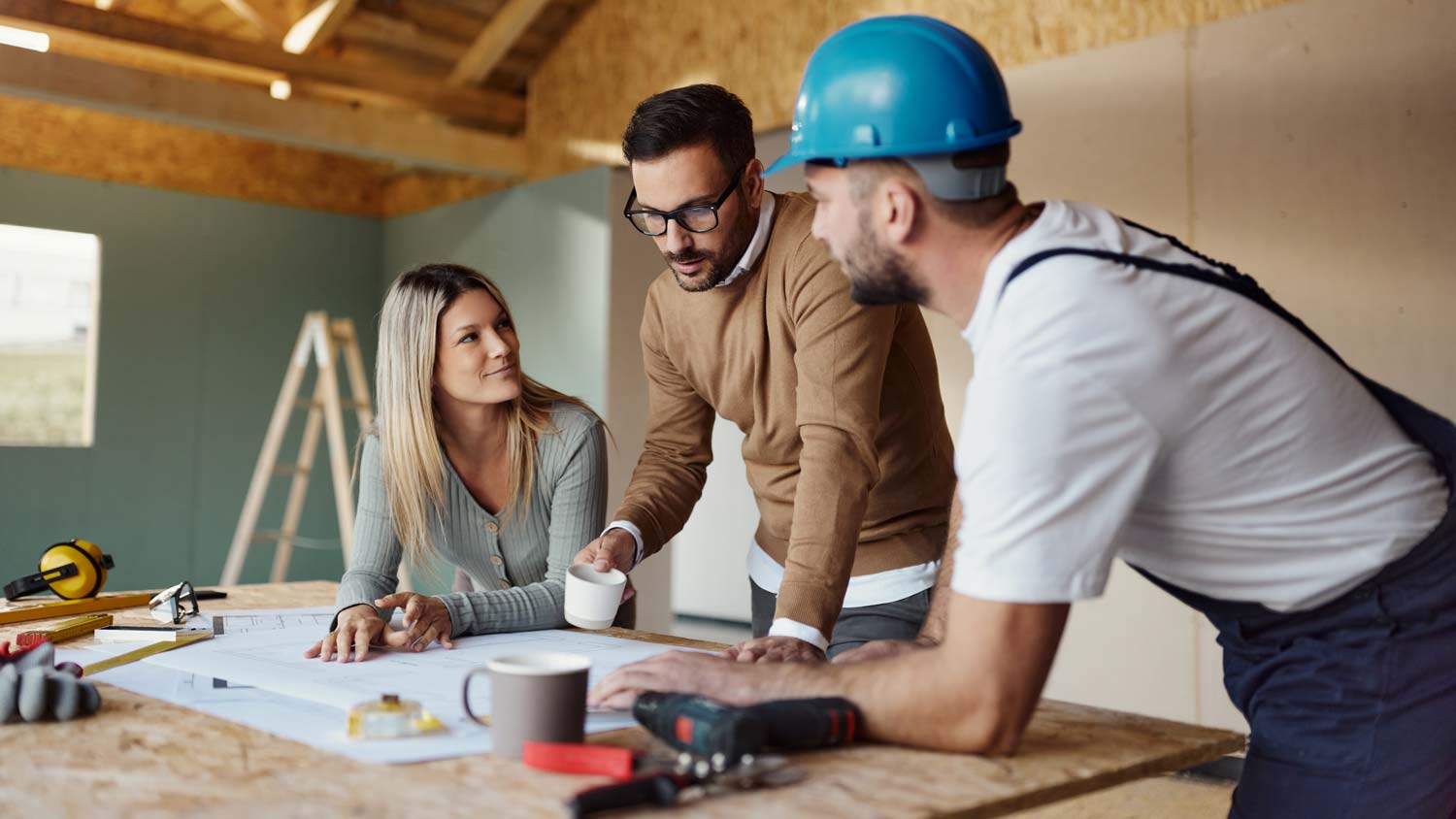 couple talking about house design with engineer