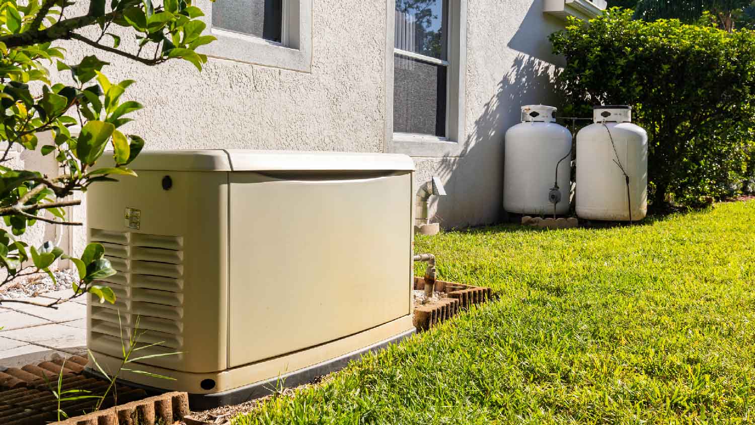 A house generator in the backyard of a house