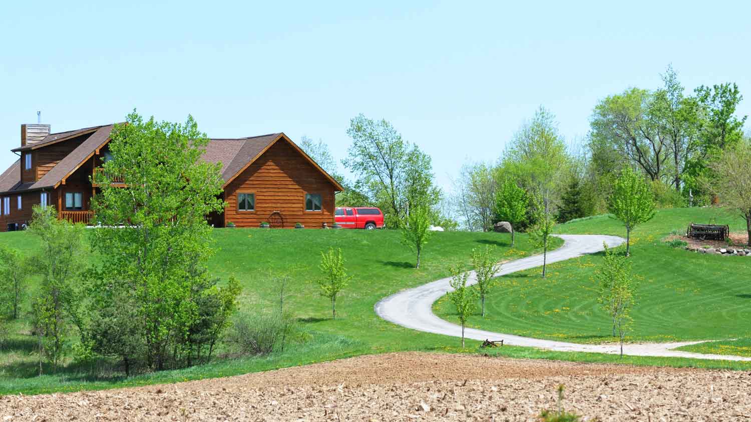 A curved driveway leading to a house on a hill