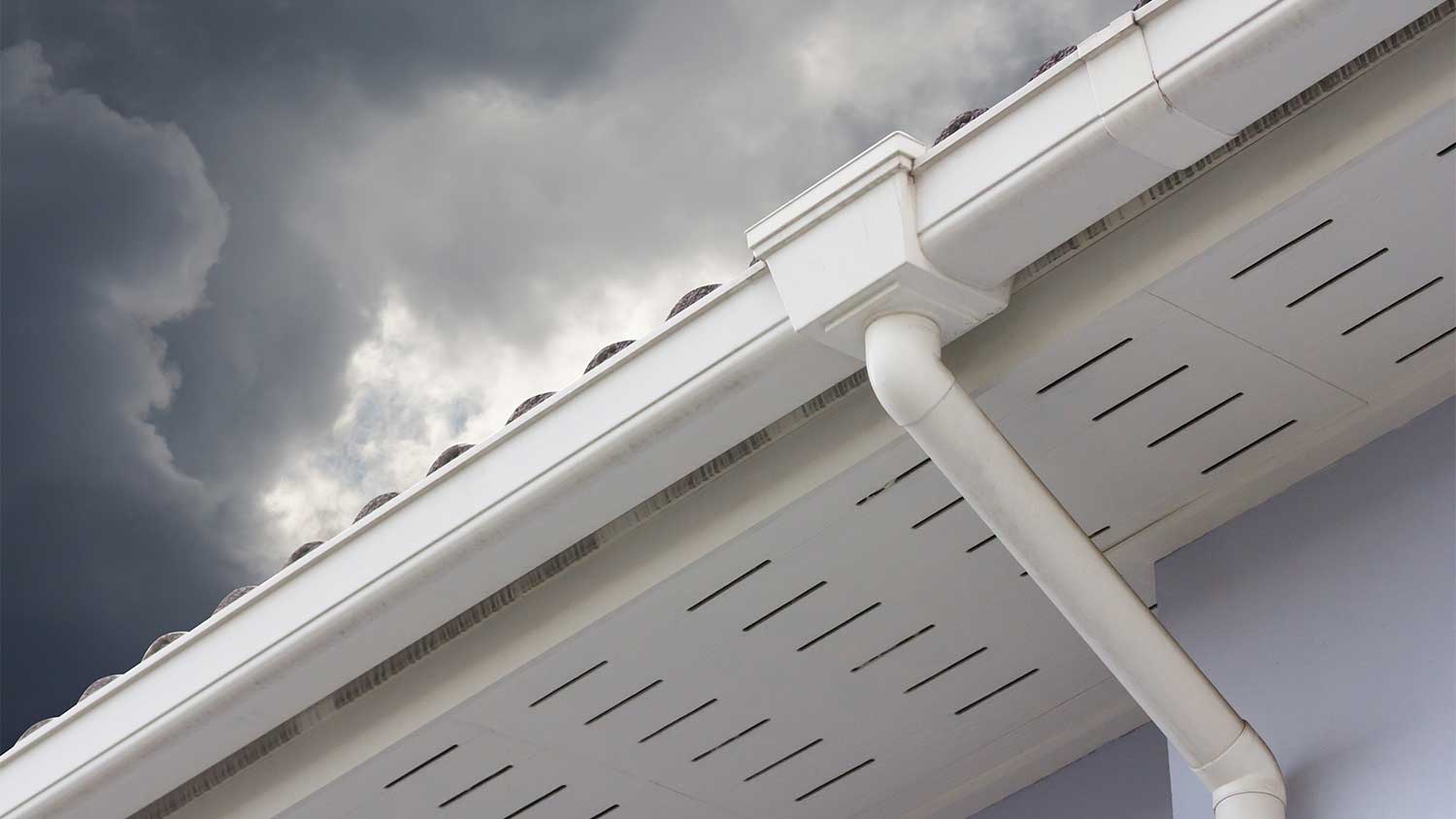 A view of a house with seamless gutters on a cloudy day