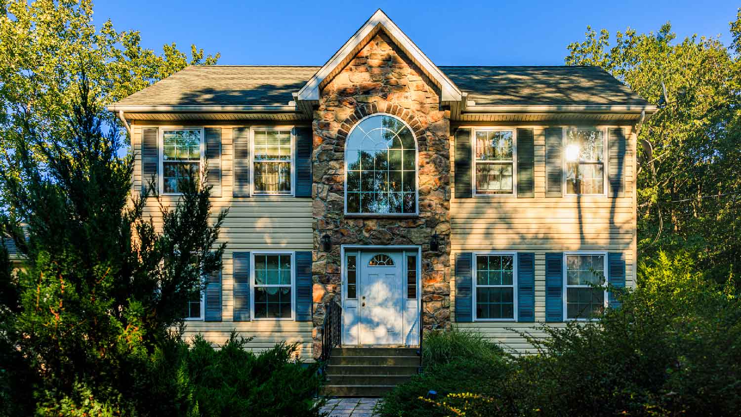 A house with beige siding on a sunny day
