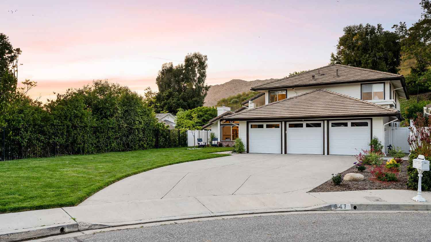 A house with a driveway leading to a three-car garage