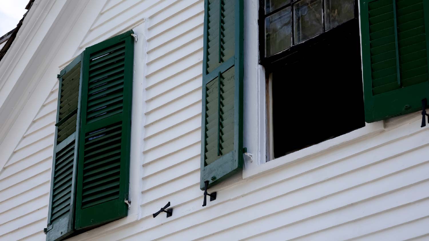 A house with white siding and green shutters