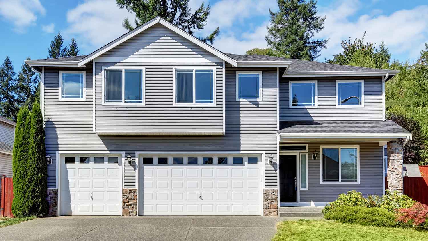 House exterior with dutch lap siding and concrete driveway
