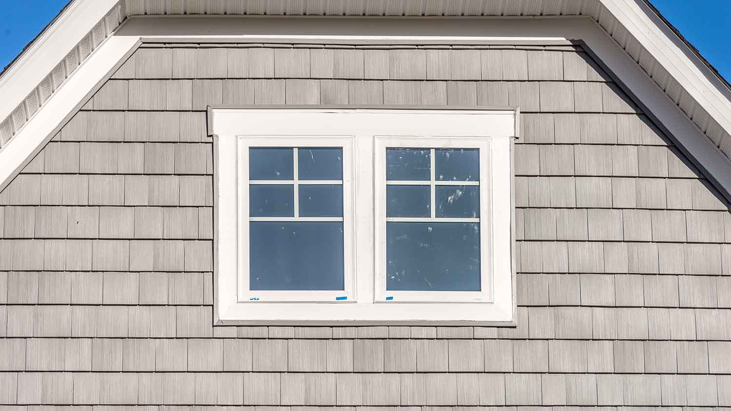 Detail of a house with gray shingle siding