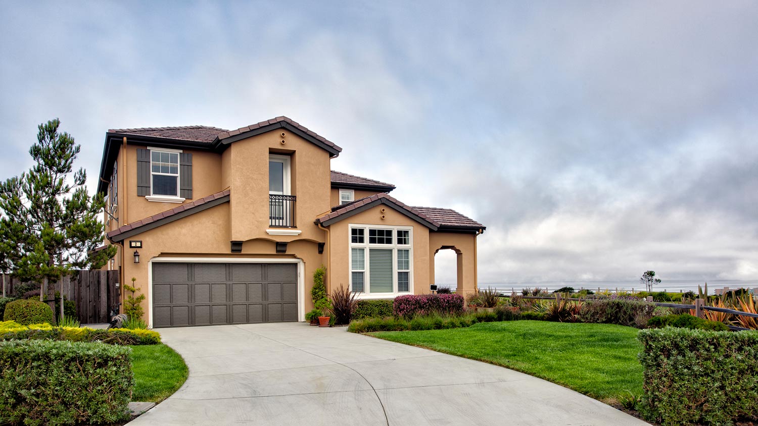 Stucco house with stormy skies above