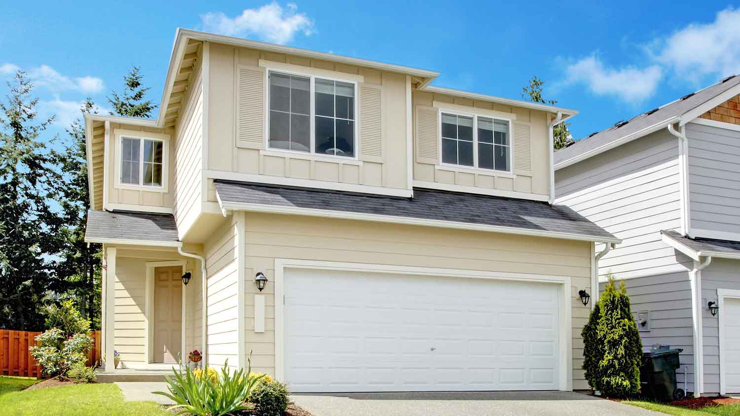 Suburban house with window shutters and beige siding