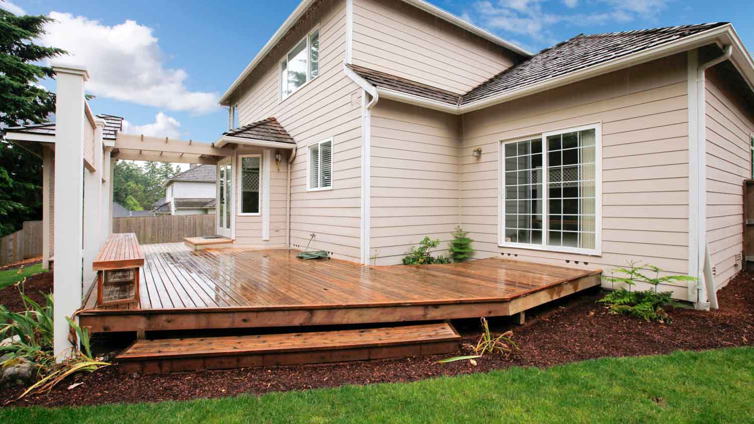 beige house with wood decking