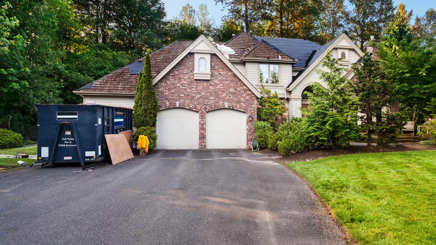 Suburban house with dumpster in front.