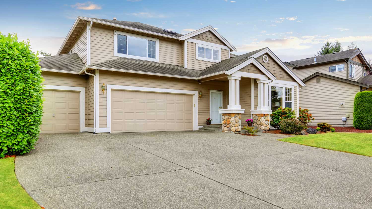 Neat beige home with two garage spaces