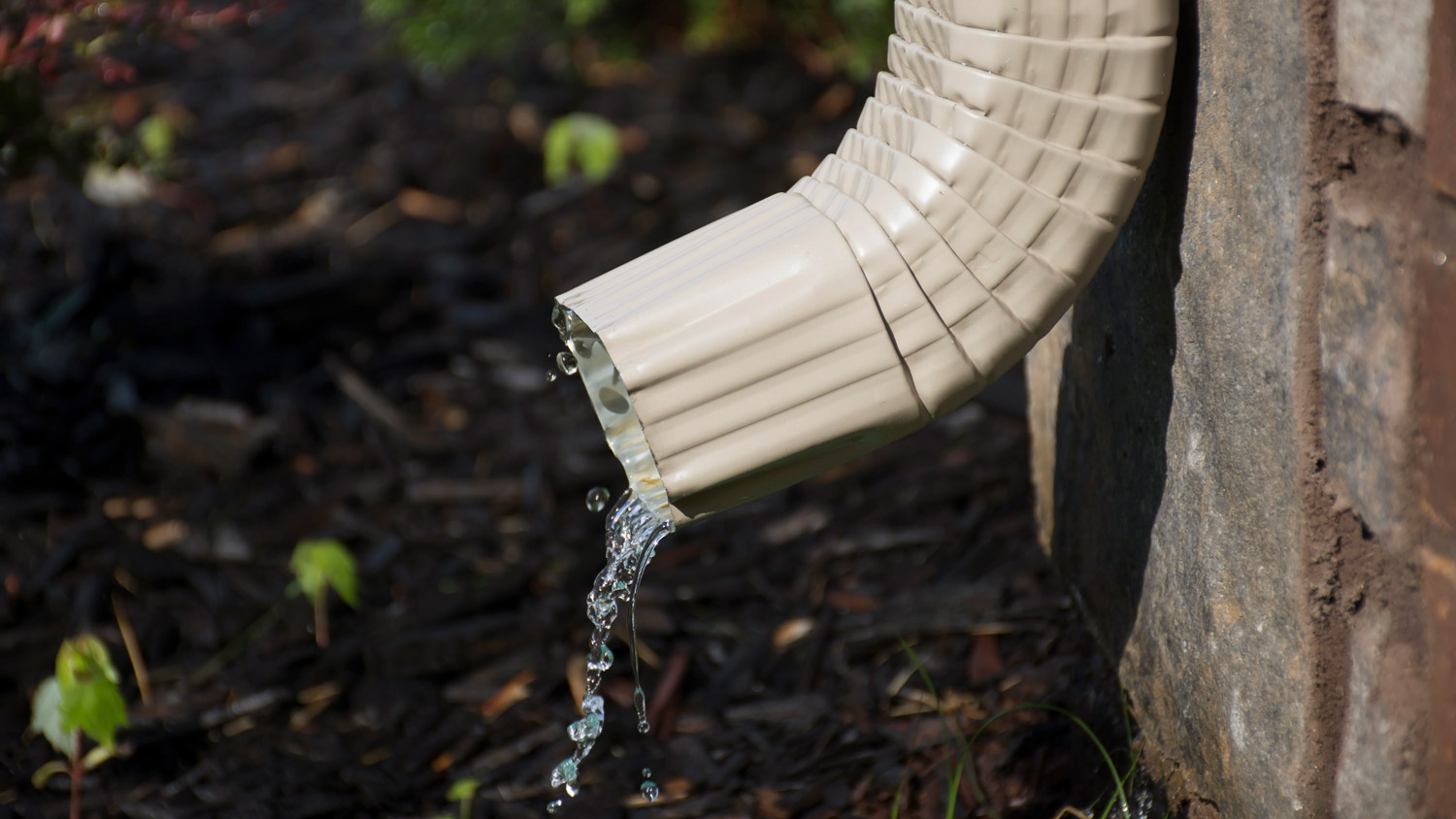 Gutter downspout with water